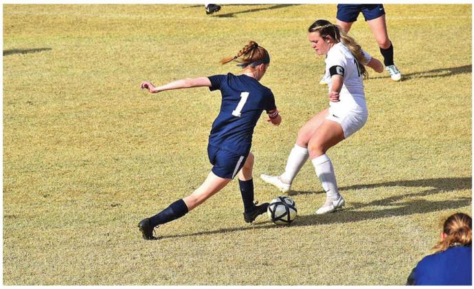 Mckenzy Isbell steals the ball from a Chickasha player