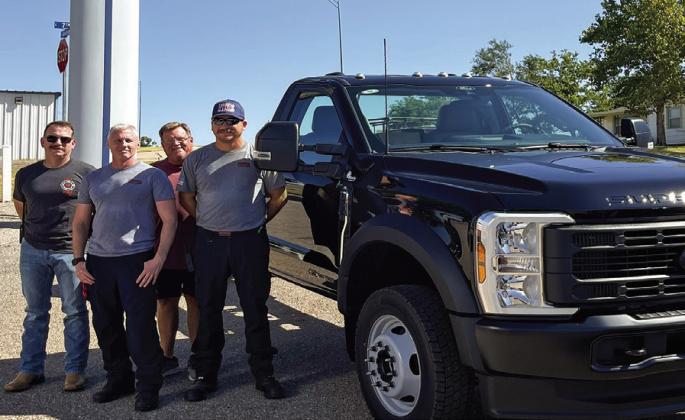 Cordell Fire Department’s Fire Chief Seth Slaughterback, along with firefighters Lincoln Hunter and Mike Morel, stand with Wheeler Ford of Cordell’s David Thaine beside the department’s new brush truck. Once fully completed and equipped, the truck will enhance the department’s ability to better serve and protect the community. The purchase of the truck was fully funded by an equipment grant. PHOTO BY BROOKLYNN PEEK