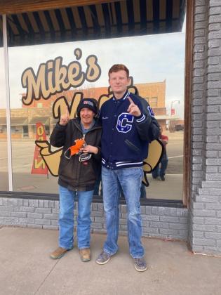 Reimer poses with his favorite customer in front of Mike's Meats.