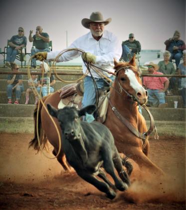 Jim Weichel chases after his steer as he prepares his lasso to rope it. PHOTOS BY CARRIE WYATT