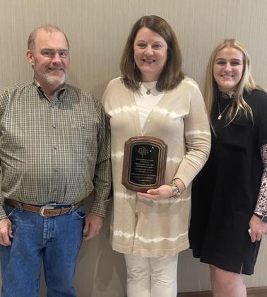 Melinda Laird, center, with proud husband Mike Laird and daughter Makila.