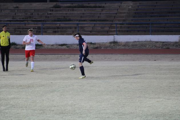 Aiden Middendorf, right, kicks the ball away from the opposing team’s player