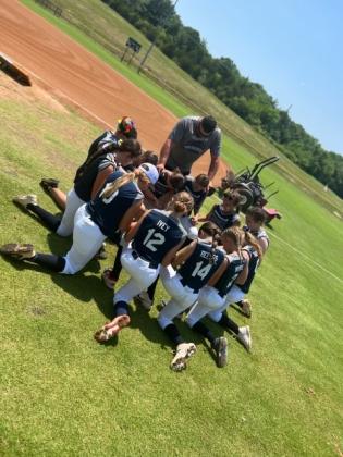12U prepares for the game with prayer. Photo by Trista Wehunt