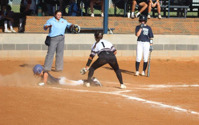 McKinley Moore, #2, sliding safe into home plate