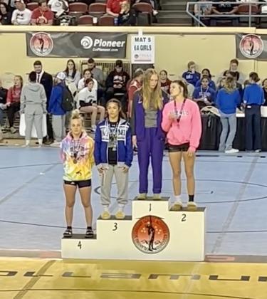 Baylor Moore standing in 4th on the podium