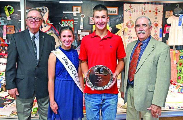 Korben Gossen receives his Grand Champion bread tray at the 2025 State Fair “Best of Wheat” Bread Baking Contest for his entry of Moist White Bread in the White Bread class. Oklahoma Wheat Commissioners Raymond Parrish, Chairman, Hunter; Bailey Gossen, Miss Elk City Teen, (also sister to Korben) and David Gammill, OWC board member, Chattanooga, present the Grand Champion ribbon and tray along with the champion tray