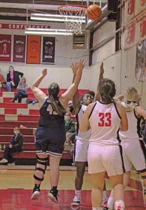 TOP LEFT: Lacey Burch and her Mema, Janie Bellah, at a Oklahoma City Thunder basketball game. ABOVE: Burch goes up for two points in a recent game.