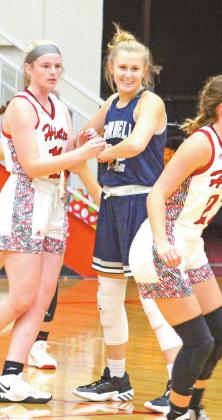 Senior Evan Anderson smiles while blocking a Hinton player in a recent game. Anderson likes to hang out with friends and has a passion for basketball.