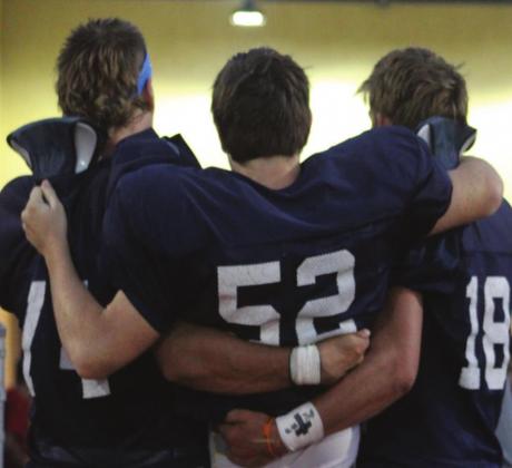 Above, Seniors Gavin Jasmer and Adden Zanghi carry injured Devon Christian off the field.