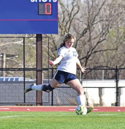FAR LEFT: Ava Willard kicks the ball with all her might SOCCER PHOTOS BY TRISTEN REIMER