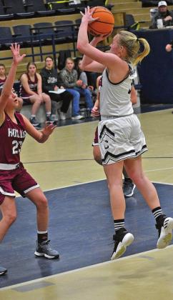 TOP RIGHT: Andrea Palmer shoots over a Hollis defender. MIDDLE RIGHT: Renee Javorsky looks to pass the ball in a game against Hollis. PHOTOS COURTESY RENE JAVORSKY AND ELLIE WILLARD