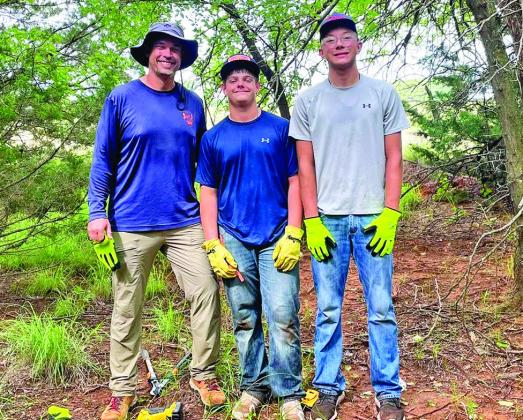 CROSSROADS TO CHAMPIONS: Coach Nick Bobeck and Cordell athletes Lucas Bynum and Bentley White clearing paths at Adams Lake