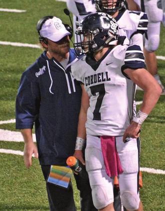 LEFT: Assistant football coach Dillon Ball gives Zanghi words of encouragement