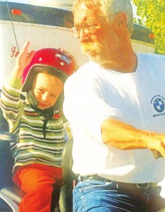 LEFT: A young Cameron and his Grandfather Mike Cochran pose before a motorcycle ride.