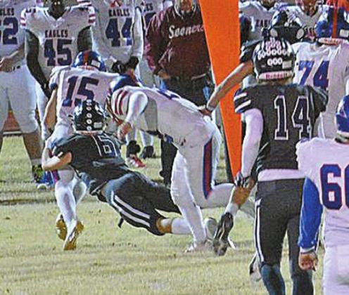 LEFT: JD Maddox tackles Eagles runner Bryce Grimaldo.   COURTESY PHOTOS BY CHARLINDA OGLE