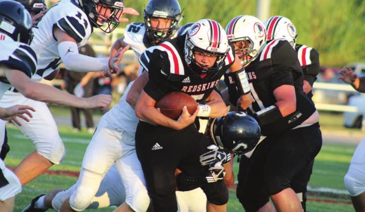 A Rush Springs Redskin is met by a wall of Blue Devils