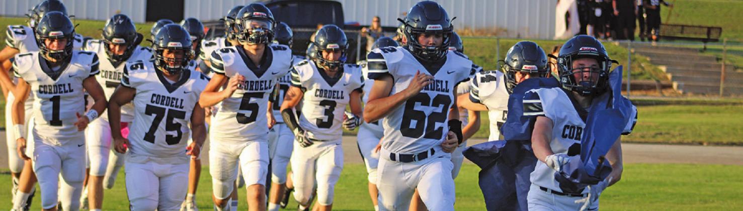 Cordell Blue Devils charge through a banner