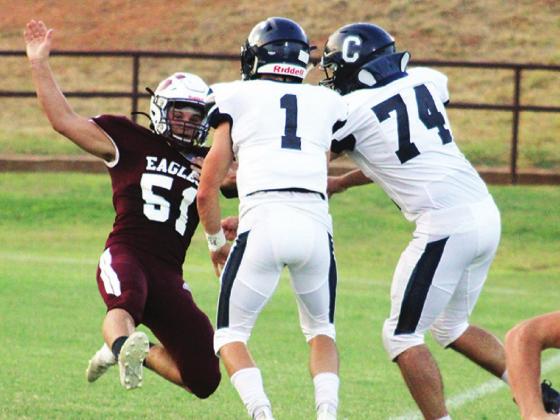 Seniors Gavin Jasmer and Dane Corbin team up to knock down an Eagle opponent.