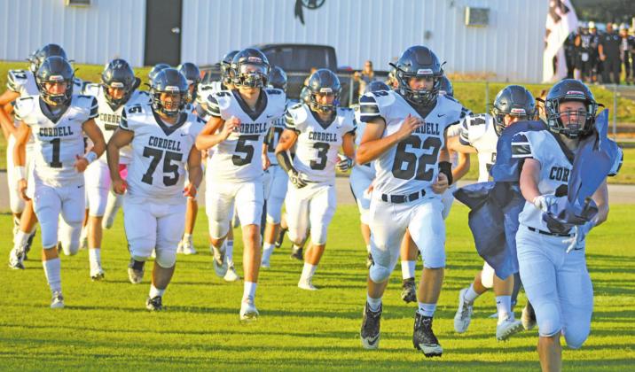 ABOVE: THE Cordell Blue Devils charge through a banner in their game against Rush Springs. PHOTOS BY BEACON STAFF