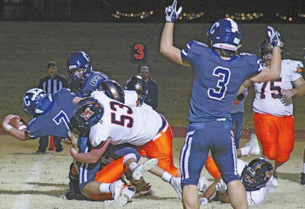 ABOVE: Senior Adden Zanghi charges through the Mangum team, scoring a touchdown.