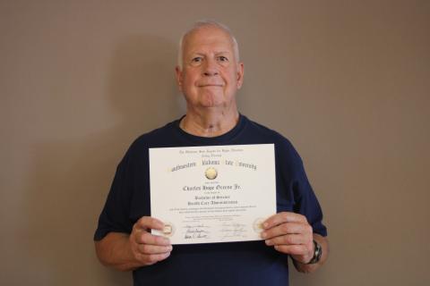Charlie Greene holding his degree