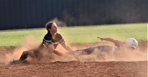 A cloud of dirt envelopes Brenyn Ball during a slide. Photo by Charlinda Ogle