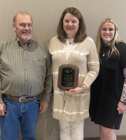 Melinda Laird, center, with proud husband Mike Laird and daughter Makila. 