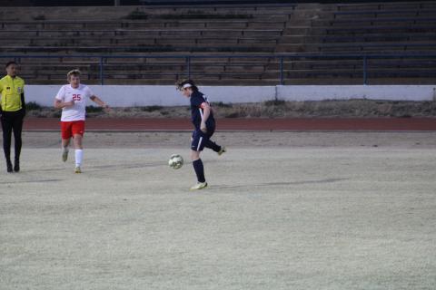 Aiden Middendorf, right, kicks the ball away from the opposing team’s player