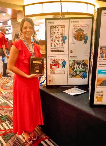 Brooklynn Peek standing next to the winning Large Space Ad