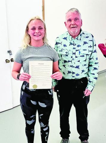 RIGHT: MAYOR PHIL KLIEWER PRESENTS BAYLOR MOORE WITH HER PROCLAMATION
