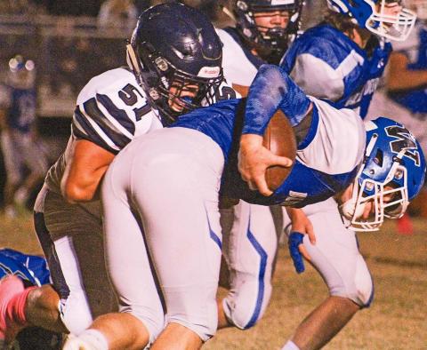 Cordell senior Gavin Jasmer demolishes a Mangum ball carrier in his team’s 39-12 win. The victory set up a Cordell home playoff football game on Friday night.