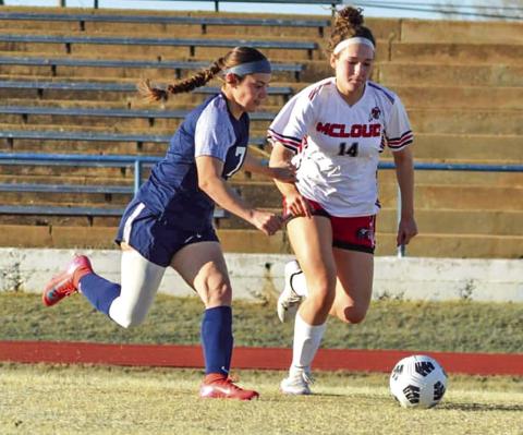 McKinsey Gray, left, runs for the ball in a game against McLoud