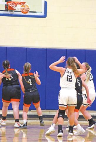 Cordell and Mangum players race for a potential rebound, but Ellie Willard sinks the free throw. PHOTOS BY FLORA A. WALTERS