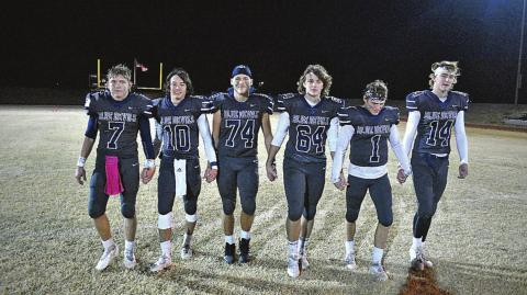 Cordell senior football players, from left, Adden Zanghi, Raydon Kuehne, Gavin Jasmer, Cameron Cochran, Dane Corbin and Bode Gallagher walk the field, hand-in-hand, as part of their post-game tradition. The seniors propelled Cordell to a play off win. COURTESY PHOTO BY CHARLINDA OGLE