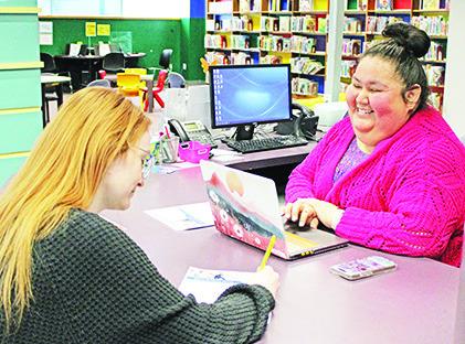 Western Plains Library Systems’ Director of Digital Inclusion and Social Benefits Sara WhiteShield (right) helps patron Madison Wright navigate resources with WPLS Pathways.
