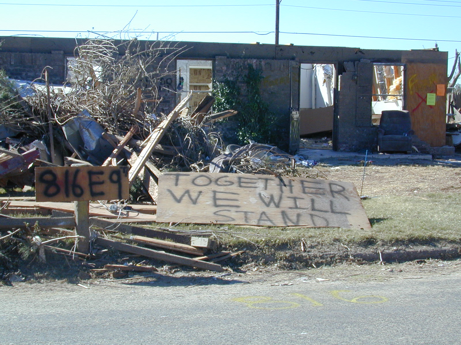A destroyed home on 9th Street displaying a sign saying, “Together we will stand.” A message that resonated with many residents the day of the tornado as well as the following weeks.