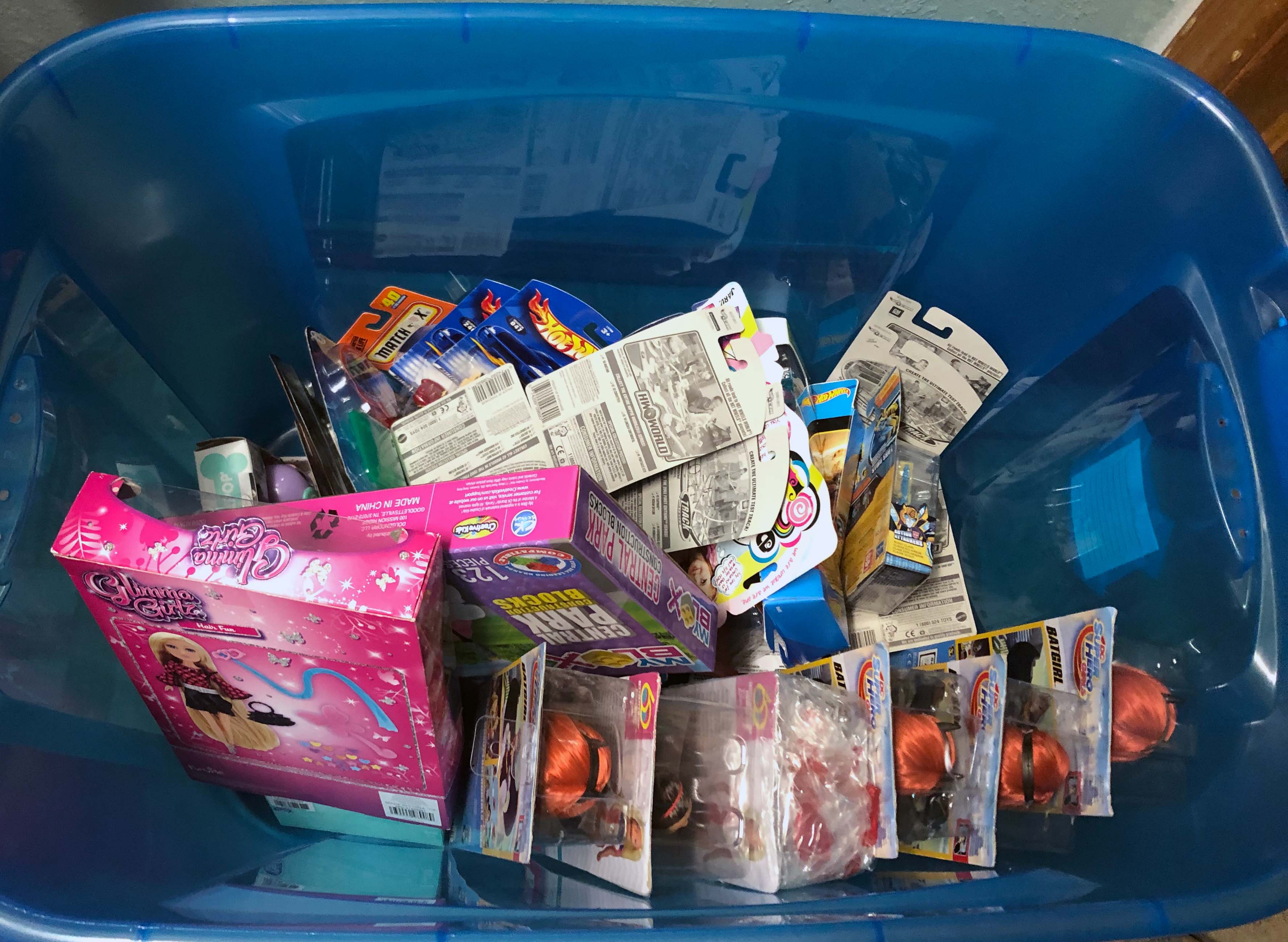 Tubs of un- wrapped toys and other items are stored until they are ready to be wrapped and sent out.