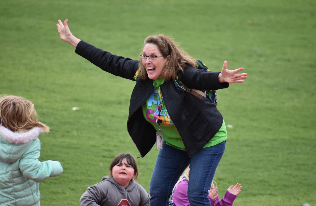 Mrs. Horn cheers her students to the finish line as they complete the 50 yard dash during the Little Olympics. CONTRIBUTED PHOTO