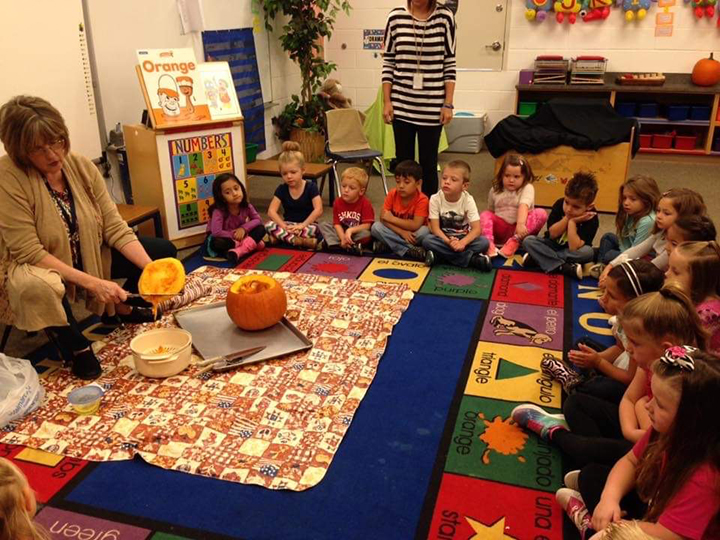 Students huddle around Mrs. Horn as she shows them the inside of a pumpkin during the annual pumpkin study. BELOW: Mrs. Horn playfully poses for an Easter photo. CONTRIBUTED PHOTOS