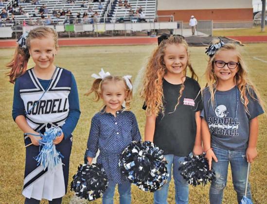 These adorable little cheerleaders were excited to see the Blue Devils take the Homecoming win! L-R: Maren Reimer, Bennett Ball, Brylee Ball, Cayce Gregg. Photo by Carlie Banks.