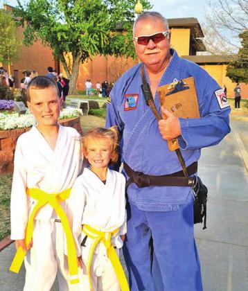 ABOVE: Sensei Pollman poses with two of his students.