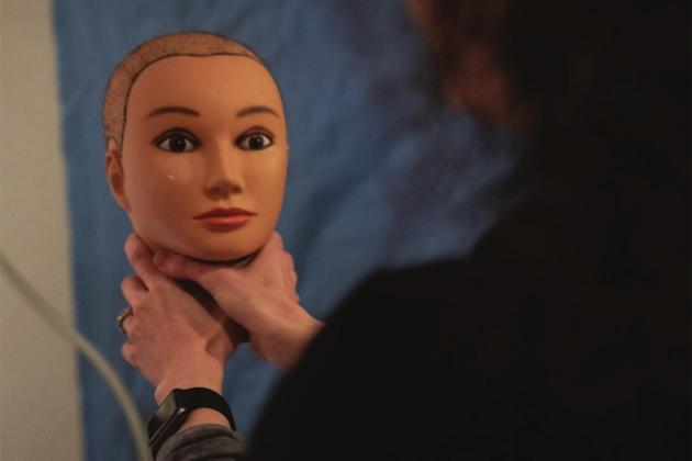 Jessica Collett, nurse examiner at the Women’s Resource Center in Norman, demonstrates the dangers of strangulation on a mannequin head at the Rape Crisis Center. Nurses offer the mannequins to victims when they are asked to recount details of their attack. Whitney Bryen/Oklahoma Watch