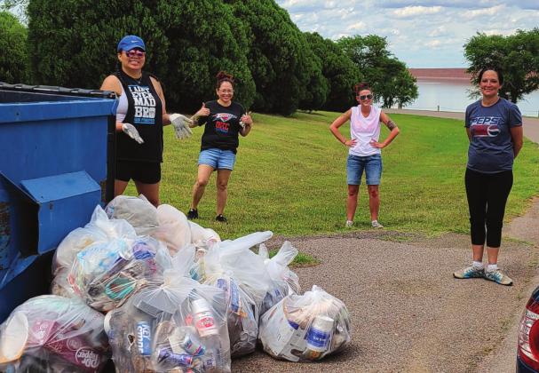 Four treatment court participants smile as they prepare to dispose of 18 bags of trash collected May 27, 2020. Photo courtesy of Sarah Mears-Ivy