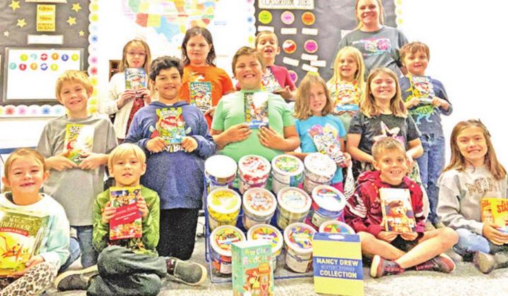 Below: Second grade teacher Kodie Price and her class are ready to get to work with new books and math tools