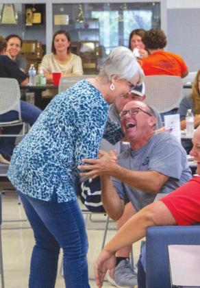 A celebration occurs between faculty members after being one of the winners of the raffle. PHOTO BY HECTOR LUCAS