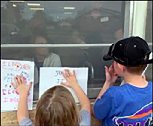 Two children share their art with Cordell Christian Home residents during lockdown. Photo courtesy of Cordell Christian Home.