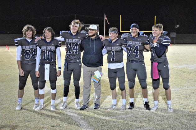 Cordell football coach Zane Trammell stands with his team after their playoff win over BFDC.