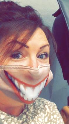 Candy Rogers shows off her mask with a big smile.