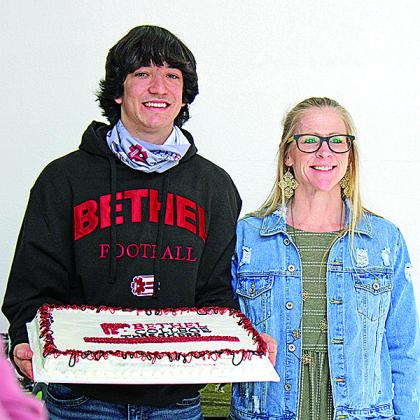 Raydon Kuehne poses with Alisa Boecker, who baked his cake.
