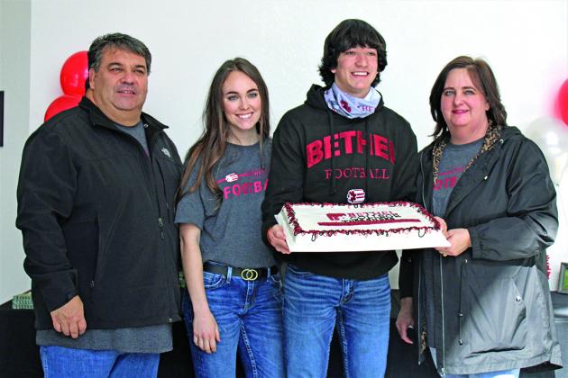 The Kuehnes pose for a quick picture with Raydon's cake.